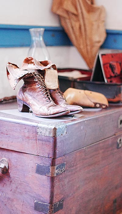 image of ladies victorian boots and a trunk at the Baldwin Home Museum. 